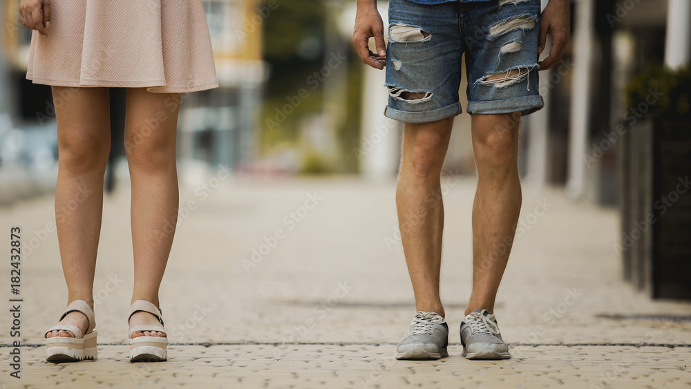 Young man and woman standing in city street, students on date, new generation