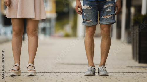 Young man and woman standing in city street, students on date, new generation