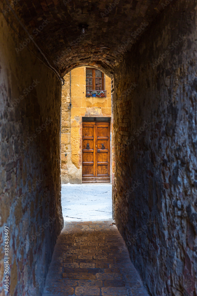 Fototapeta premium Dark mysterious old narrow alley to the street