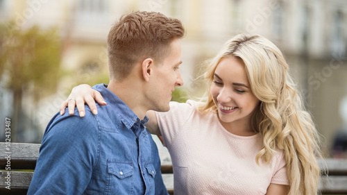 Tender student couple hugging with smiles on faces, first love story, happiness