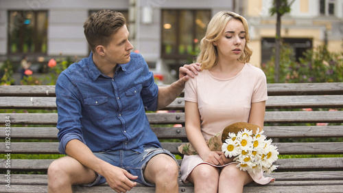 Принти на полотні Young man feeling guilty, touching offended girlfriend by shoulder, relationship