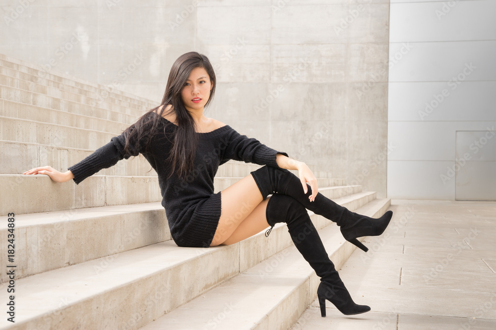 Beautiful exotic woman wearing sexy stylish black boots Photos | Adobe Stock