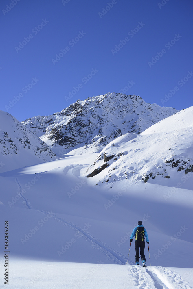 Woman cross country skiing on sunny day, Tyrol, Austria Woman cross country skiing on sunny day, Tyrol, Austria