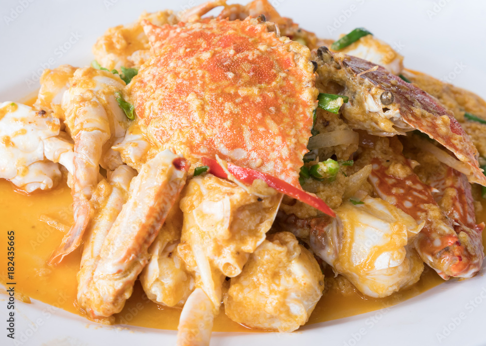 Fried crab with curry powder on the white plate. Fried crab with curry powder on the white plate.
