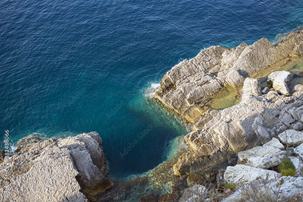 rocky cliff overlooking the blue sea rocky cliff overlooking the blue sea