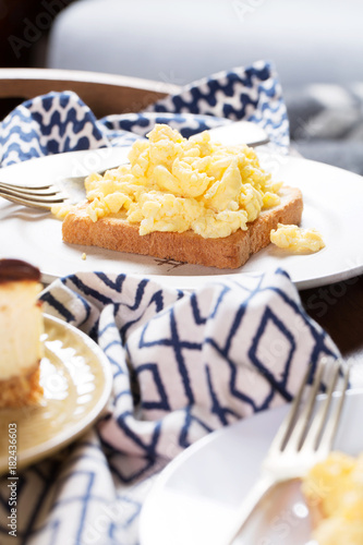Breakfast in bed for two, scrambled eggs, cheesecake, morning, vertical, selective focus