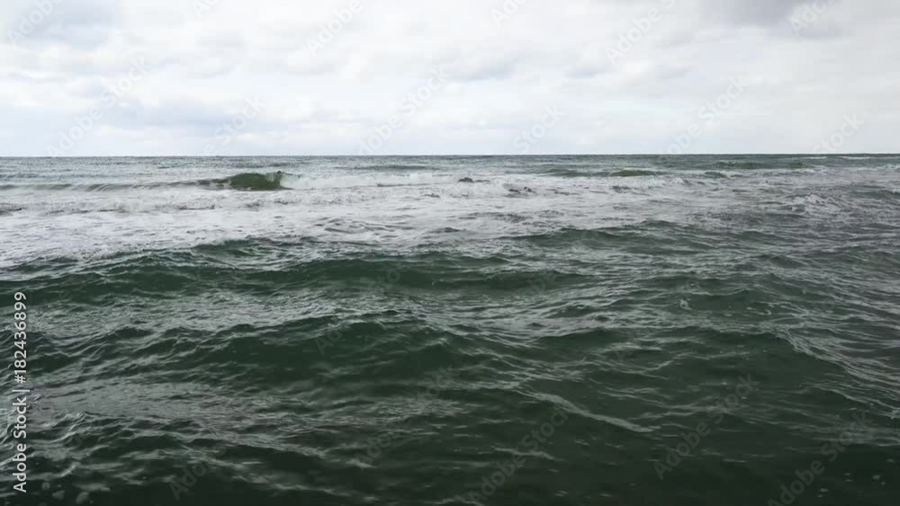 The excitement of the water near the shore, the waves in the distance at a depth and the sky with clouds The excitement of the water near the shore, the waves in the distance at a depth and the sky with clouds