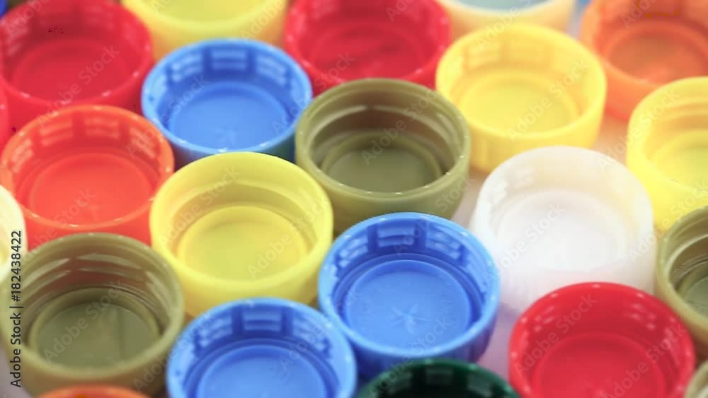 many plastic covers of different colors lined up in neat rows many plastic covers of different colors lined up in neat rows