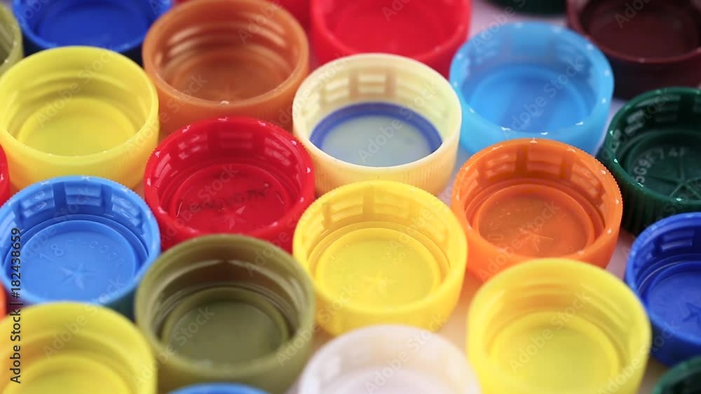 many plastic covers of different colors lined up in neat rows many plastic covers of different colors lined up in neat rows