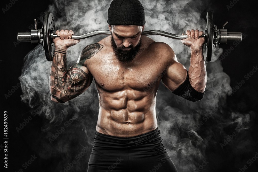 Muscular young fitness sports man workout with barbell in fitness gym Muscular young fitness sports man workout with barbell in fitness gym