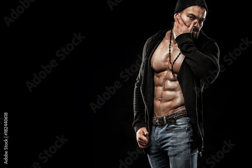 Obraz na plátně Handsome fit man posing wearing in jeans with tattoo