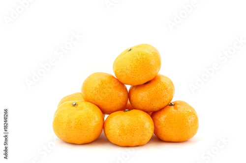 Pile of many orange fruits on white background, side view