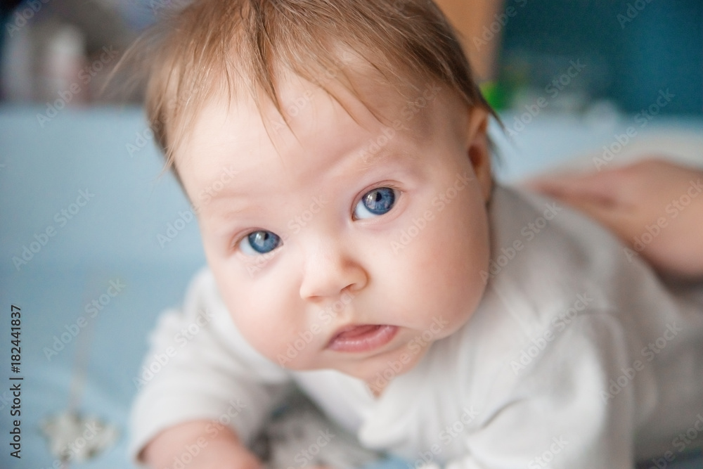 The baby lies on his tummy, lifts his head. The baby lies on his tummy, lifts his head.