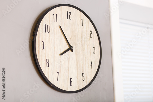 Five minutes to eight o clock on the dial round wall clock