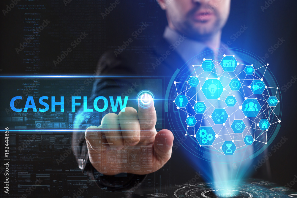 The concept of business, technology, the Internet and the network. A young entrepreneur working on a virtual screen of the future and sees the inscription: Cash flow The concept of business, technology, the Internet and the network. A young entrepreneur working on a virtual screen of the future and sees the inscription: Cash flow