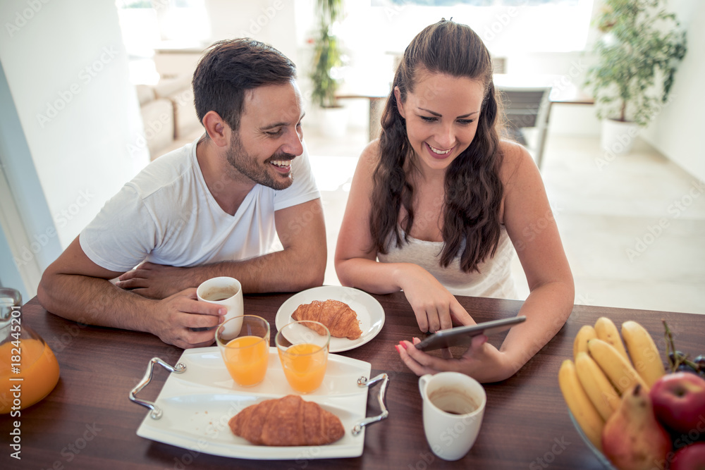 Couple having breakfast in kitchen. Couple having breakfast in kitchen.