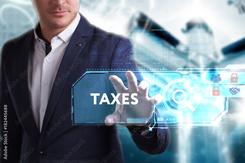 Business, Technology, Internet and network concept. Young businessman working on a virtual screen of the future and sees the inscription: Taxes