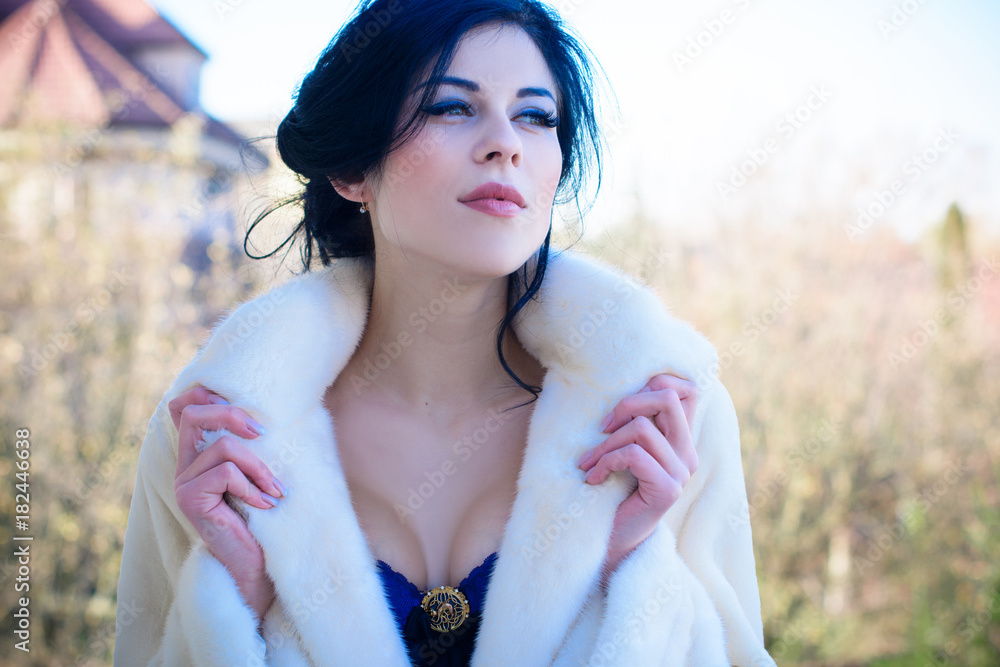 Portrait of a beautiful young adult attractive sexy and sensuality pretty  brunette woman in blue erotic lingerie and white fur coat, lady with big  boobs, plastic surgery for women Stock Photo
