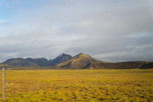 Highland in Iceland. Mountains with green moss on cloudy sky