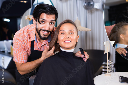Male professional with female talking about hairstyle