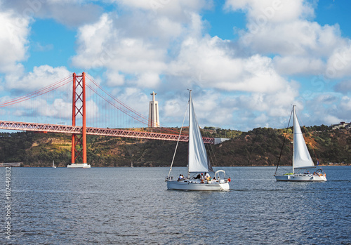 Bridge of 25th april with yachts in Lisbon.