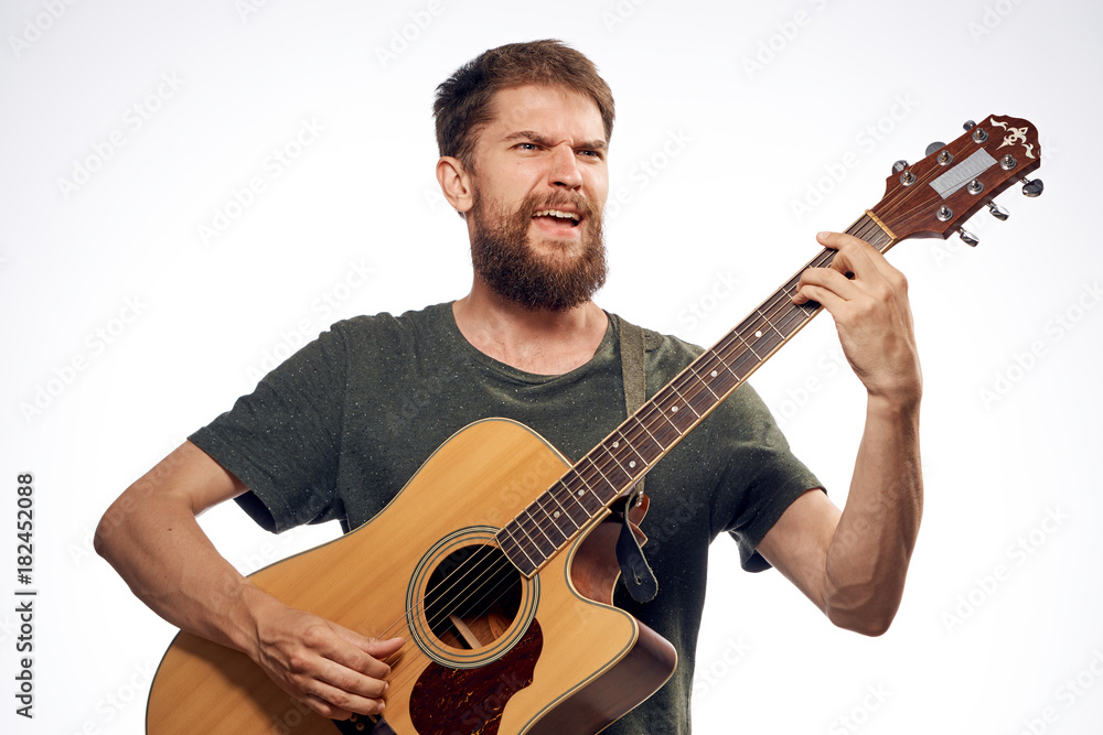 Man with beard playing guitar on white isolated background Man with beard playing guitar on white isolated background