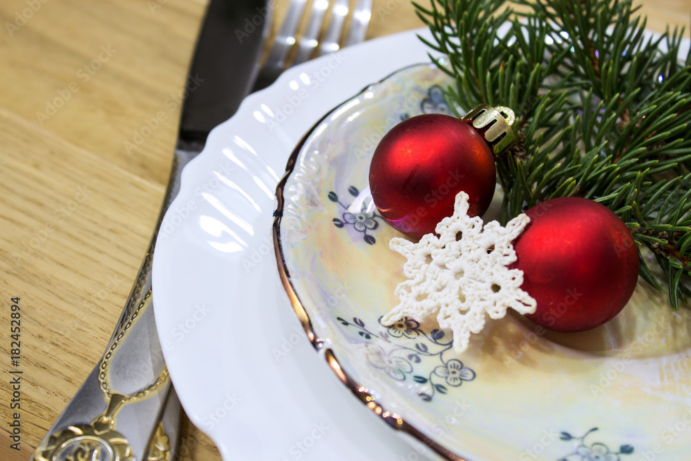 Festive table with Christmas decorations. Plates with festive decor. Close-up. Festive table with Christmas decorations. Plates with festive decor. Close-up.