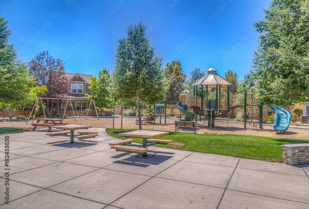 Playground in park with picnic benches