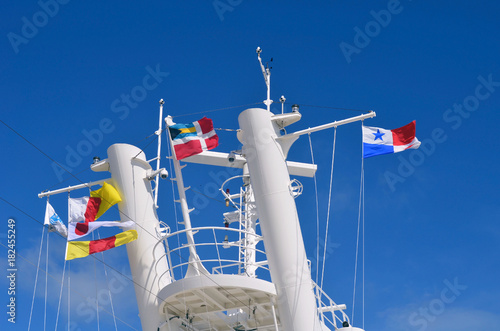 Flying ensigns and flags on a Caribbean cruise ship.
