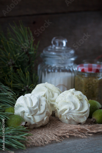 Winter feijoa tasted zephyr or marsmallows on the wooden background photo