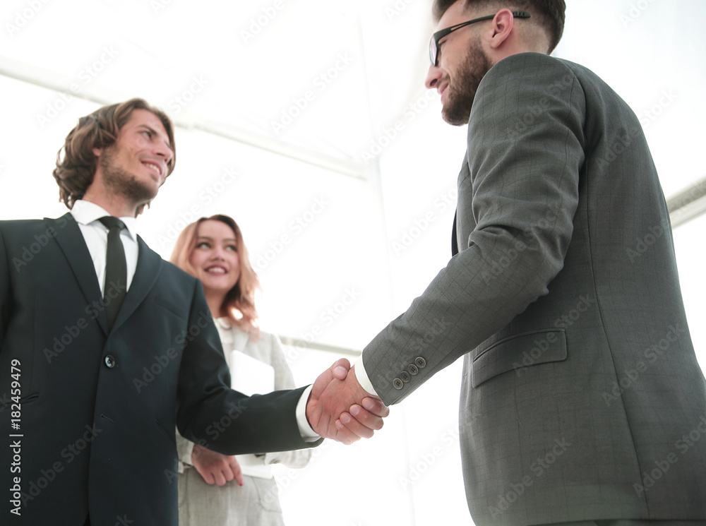 Photo of handshake of two happy businessmen