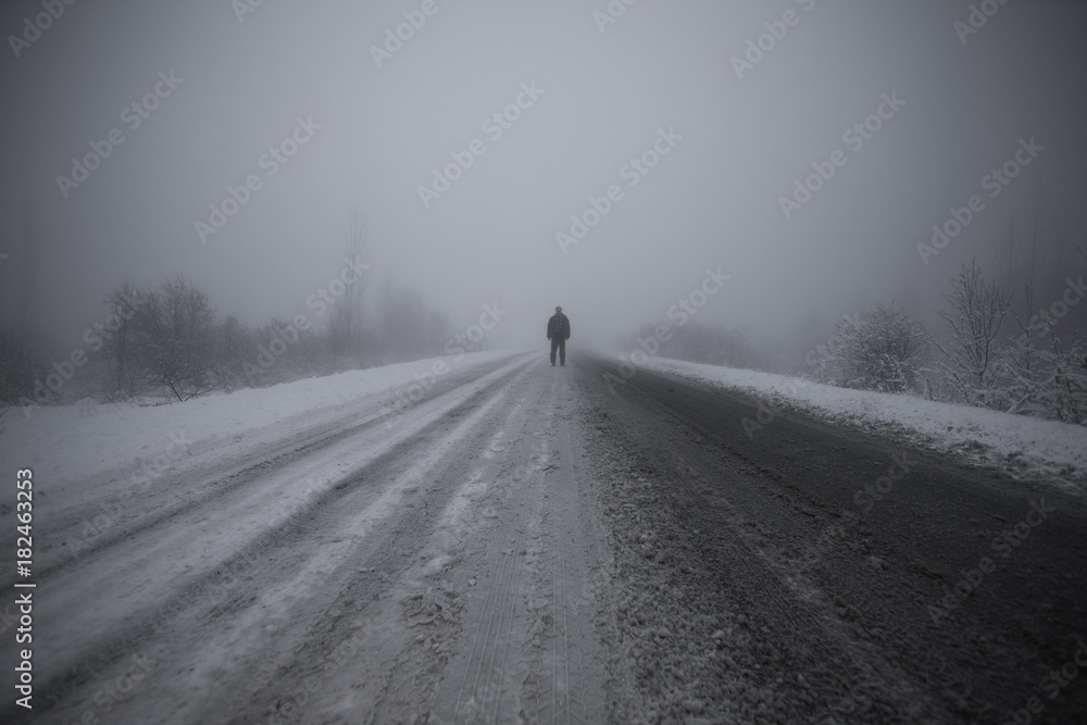 man in the fog on the road