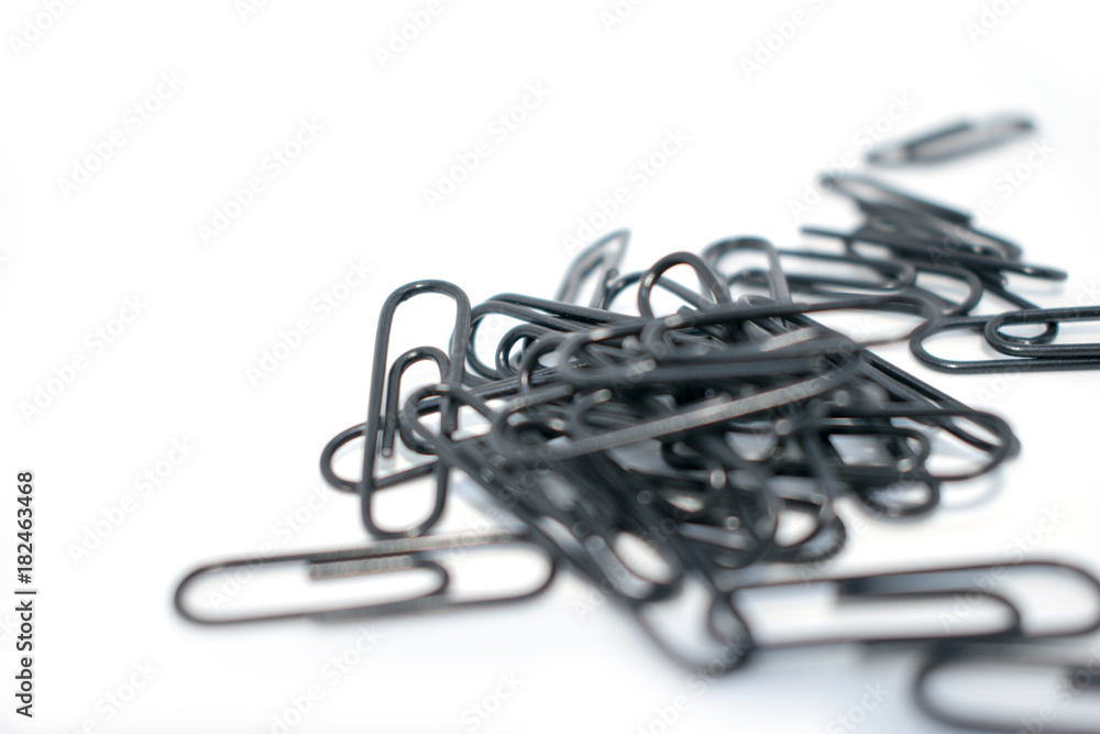 Clip for office accessories. Stationery. Black clips in a chaotic order. Clip for office accessories. Stationery. Black clips in a chaotic order.