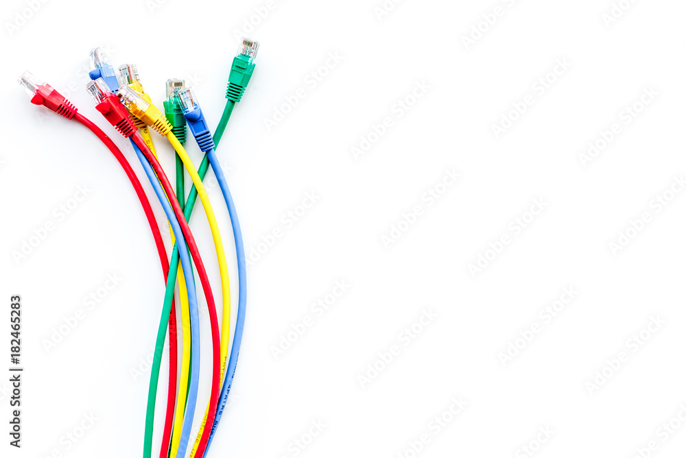 Colored patch-cord on white background top view copyspace