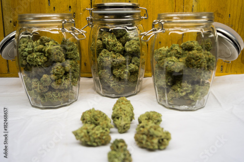 Cannabis flowers in jar with flowers in front 1 