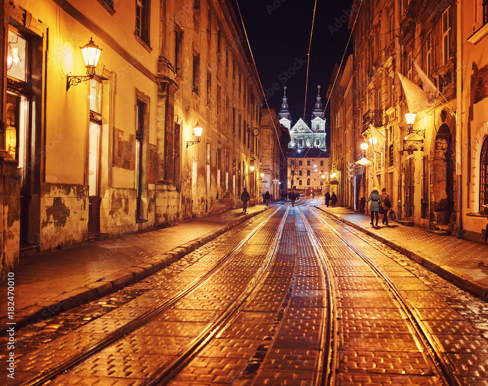 Mysterious narrow alley with lanterns in an old European city