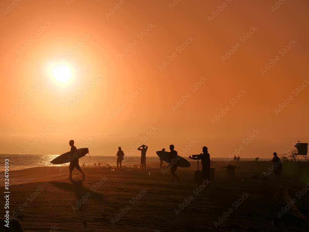 Golden hour on the California beach, surfers, photographers, people