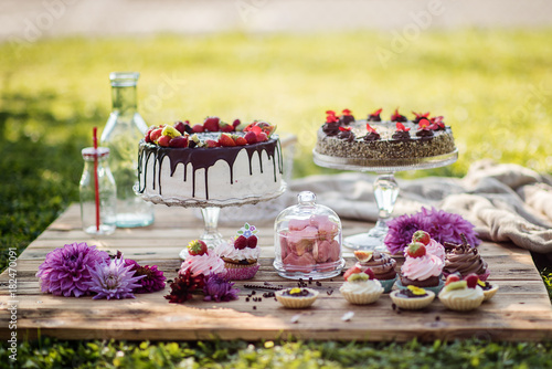 selection of tasty desserts and cakeson old wood background