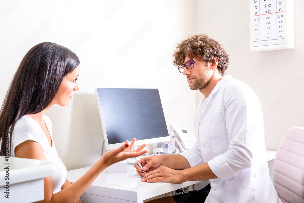 A Doctor writing a prescription in the Consultation room A Doctor writing a prescription in the Consultation room
