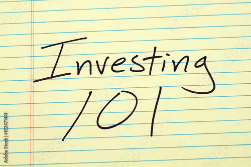 The words "Investing 101" on a yellow legal pad