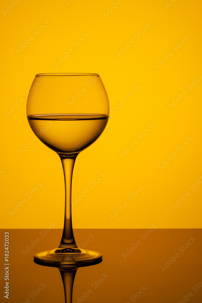 a glass of water on a yellow background a glass of water on a yellow background
