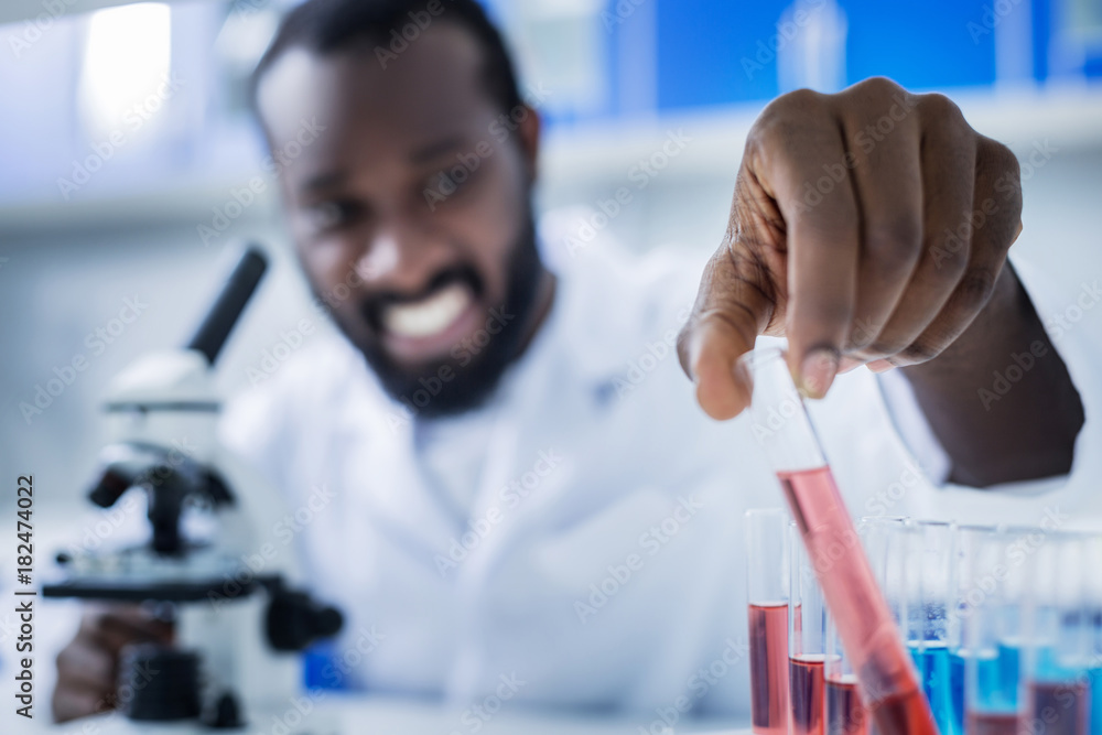 Test samples. Selective focus of a test tube being taken from the rack for analysis Test samples. Selective focus of a test tube being taken from the rack for analysis