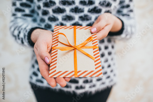 The girl presents a gift Christmas envelope