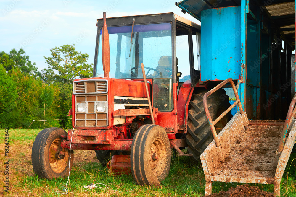 Obraz premium Tractor and milking parlor in field