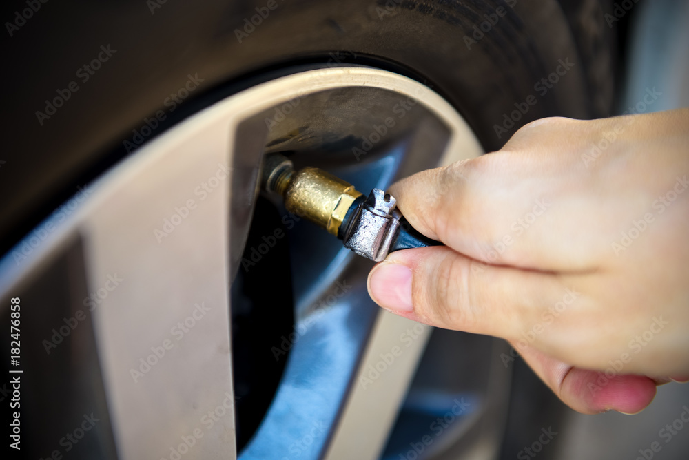 Filling air into a car tire Filling air into a car tire