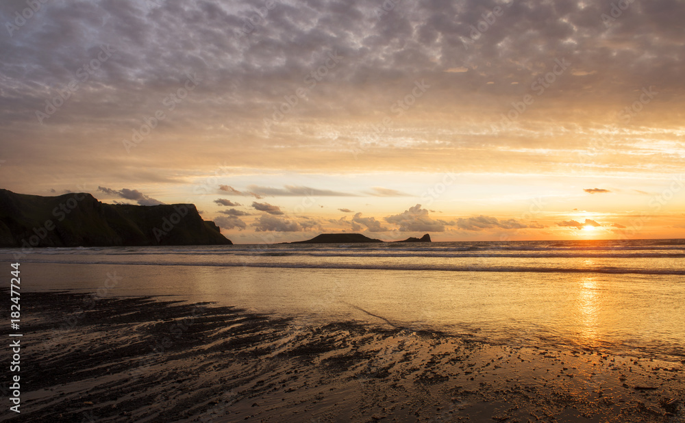 Landscape image of Wormshead, taken from Rhossili beach at sunset 