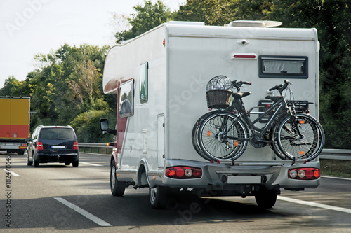 Caravan with bicycles and cars in road at Switzerland