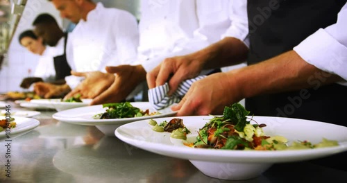 Wallpaper Mural Team of chefs garnishing meal on counter  Torontodigital.ca
