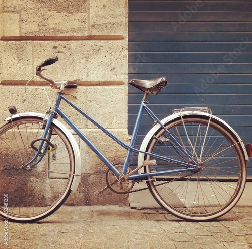 Old school retro blue and white bicycle on the street