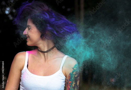 Lovely woman with purple hair having fun with on  Holi festival. Space for text